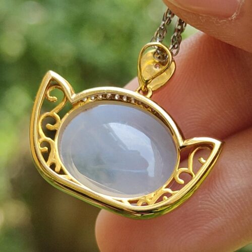 a hand holding a necklace