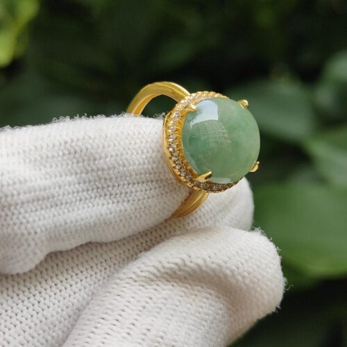 a hand wearing a glove with a ring on it