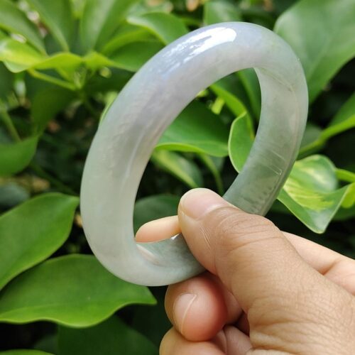 a hand holding a white circular object