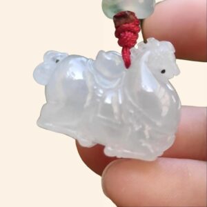 a hand holding a white animal