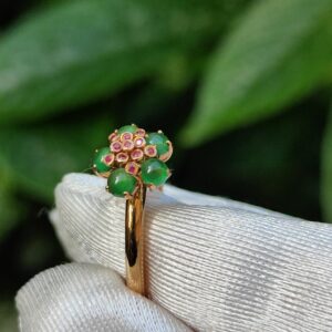 a ring with green stones on it