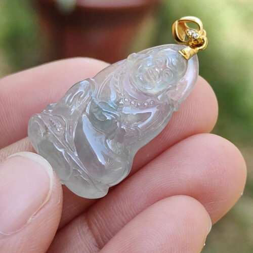 una persona sosteniendo un colgante de jade