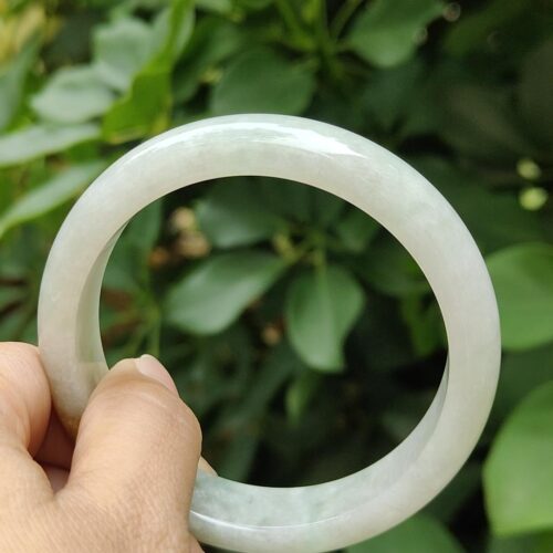 a hand holding a white circular object