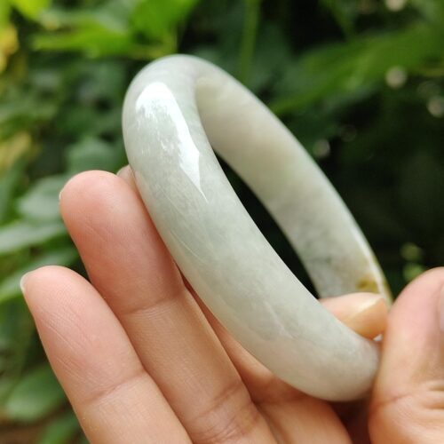 a hand holding a bracelet