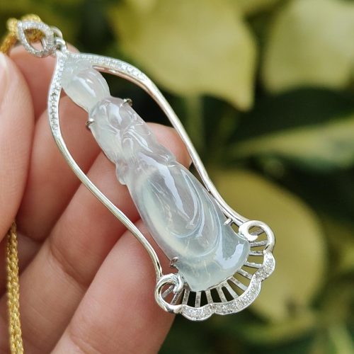 a hand holding a necklace