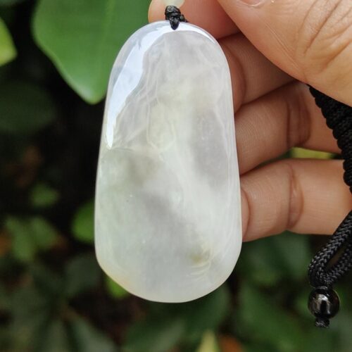 a hand holding a white stone