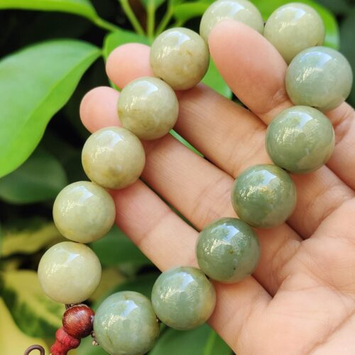 a hand holding a beaded necklace