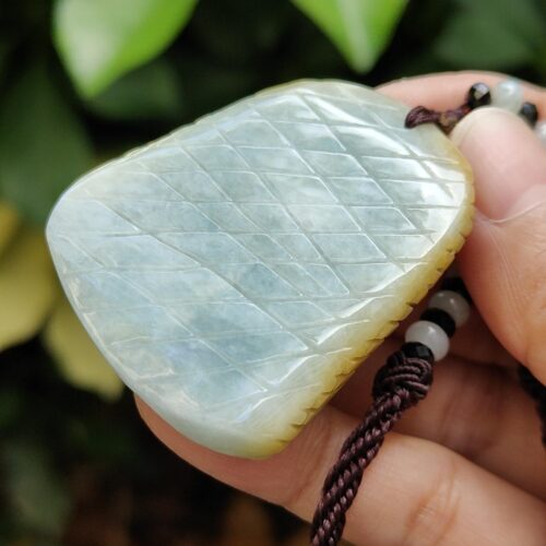 a hand holding a necklace