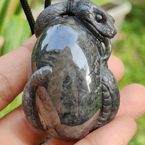 a hand holding a stone necklace