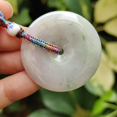 a hand holding a white round object