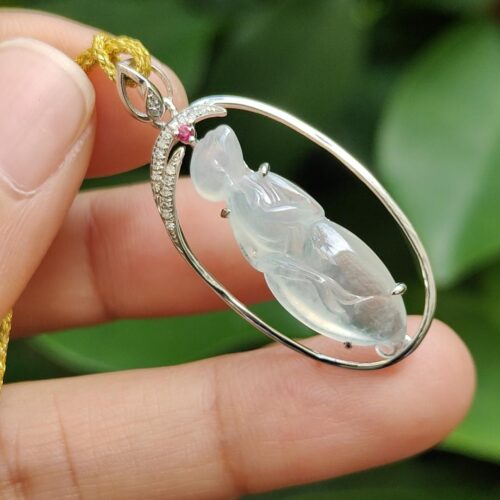 a hand holding a necklace