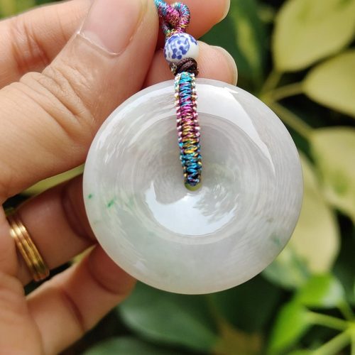 a hand holding a white round object