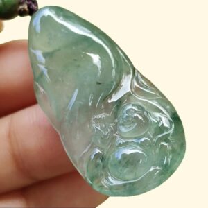 a hand holding a green stone