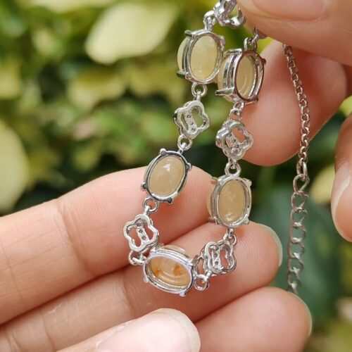 a hand holding a necklace