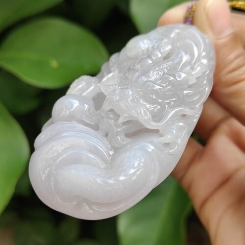 a hand holding a white stone