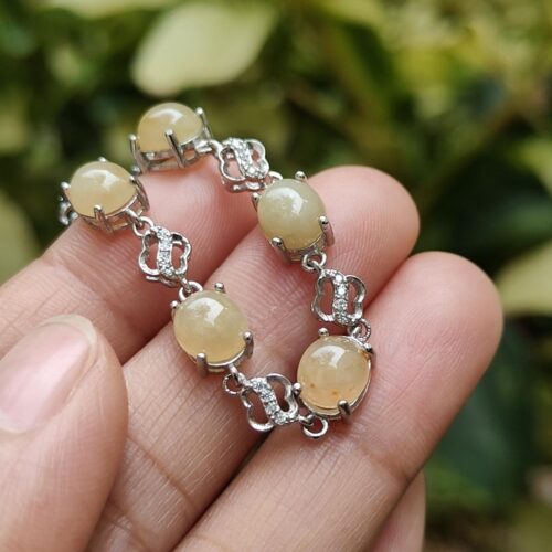 a hand holding a bracelet