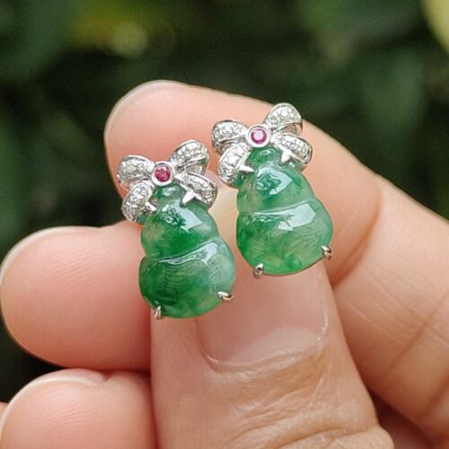 a person holding a pair of earrings