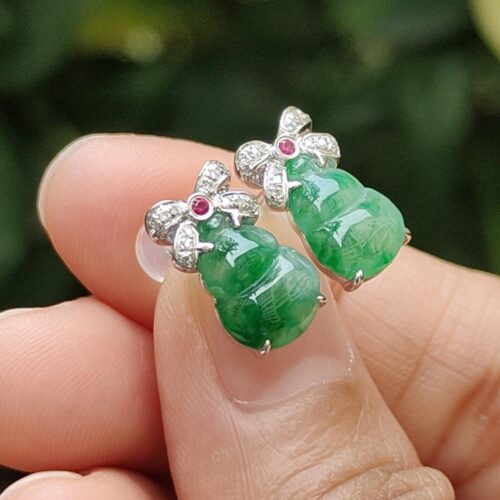 a person holding a pair of earrings