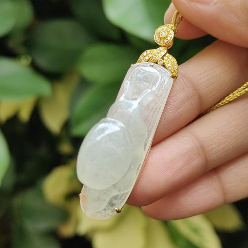 a hand holding a necklace