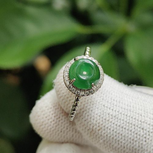 a hand wearing a glove with a ring