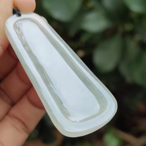 a hand holding a white rectangular object