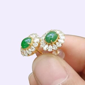 a person holding a pair of earrings