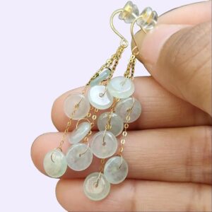 a hand holding a pair of earrings