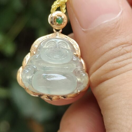 a hand holding a jade pendant