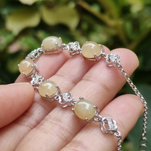 a hand holding a bracelet