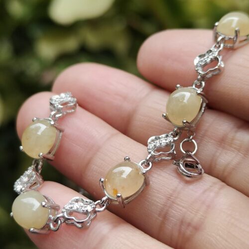 a hand holding a bracelet