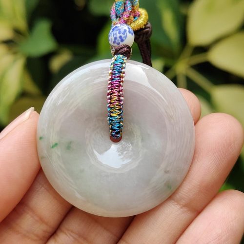 a hand holding a white round object