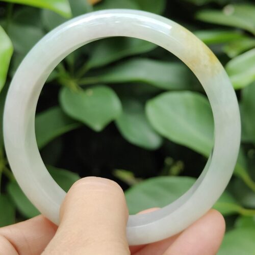 a hand holding a white circular object