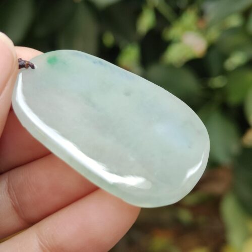 a hand holding a white stone