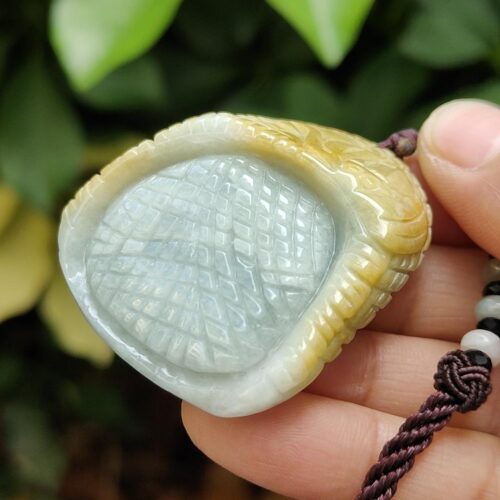 a hand holding a necklace