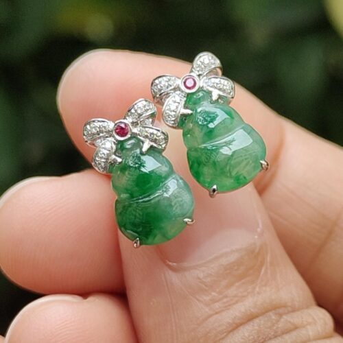 a person holding a pair of earrings