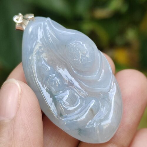 a hand holding a blue stone