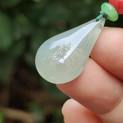 a hand holding a necklace