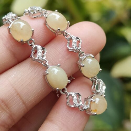 a hand holding a bracelet