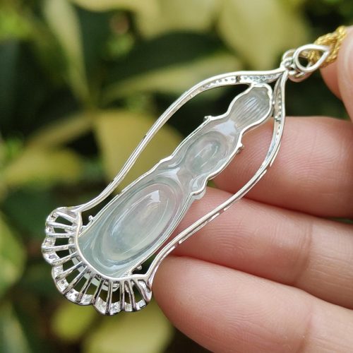 a hand holding a necklace