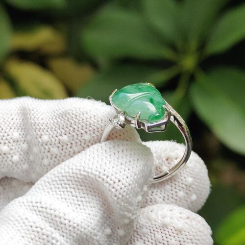 a hand wearing a glove holding a ring