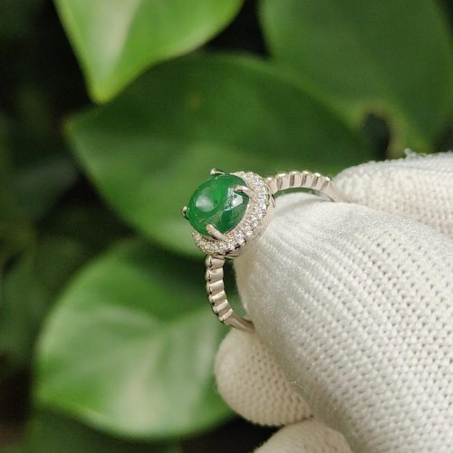 a hand wearing a glove holding a ring