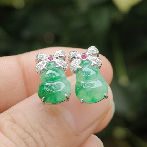 a person holding a pair of earrings