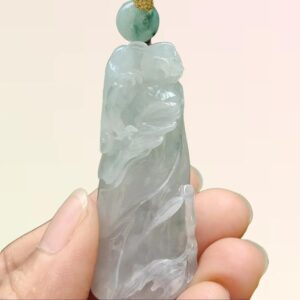 a hand holding a stone sculpture