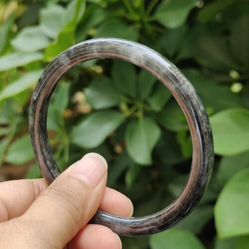 a hand holding a round object