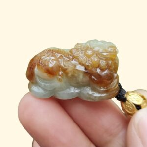 a hand holding a small stone object