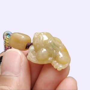 a person holding a small stone object