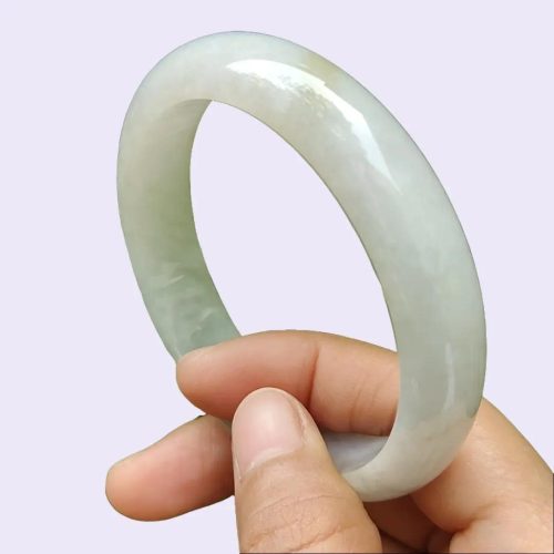 a hand holding a white bracelet