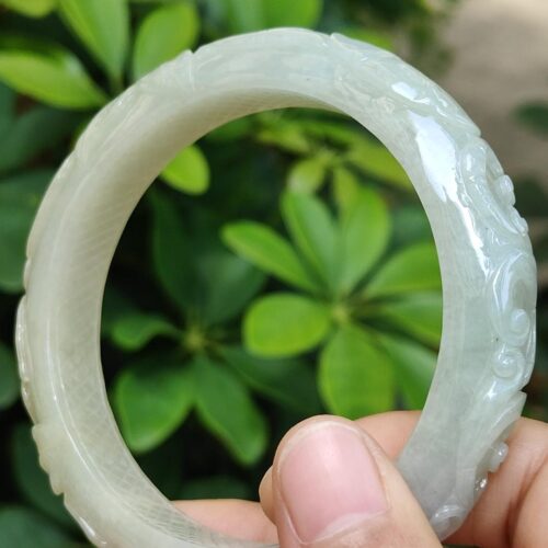 a hand holding a white bracelet