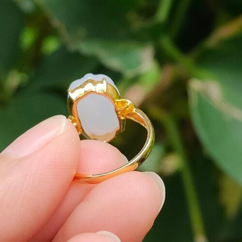 a hand holding a gold ring