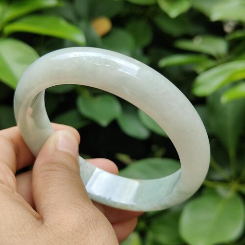 a hand holding a white bracelet